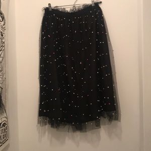 black skirt with pastel petals attached